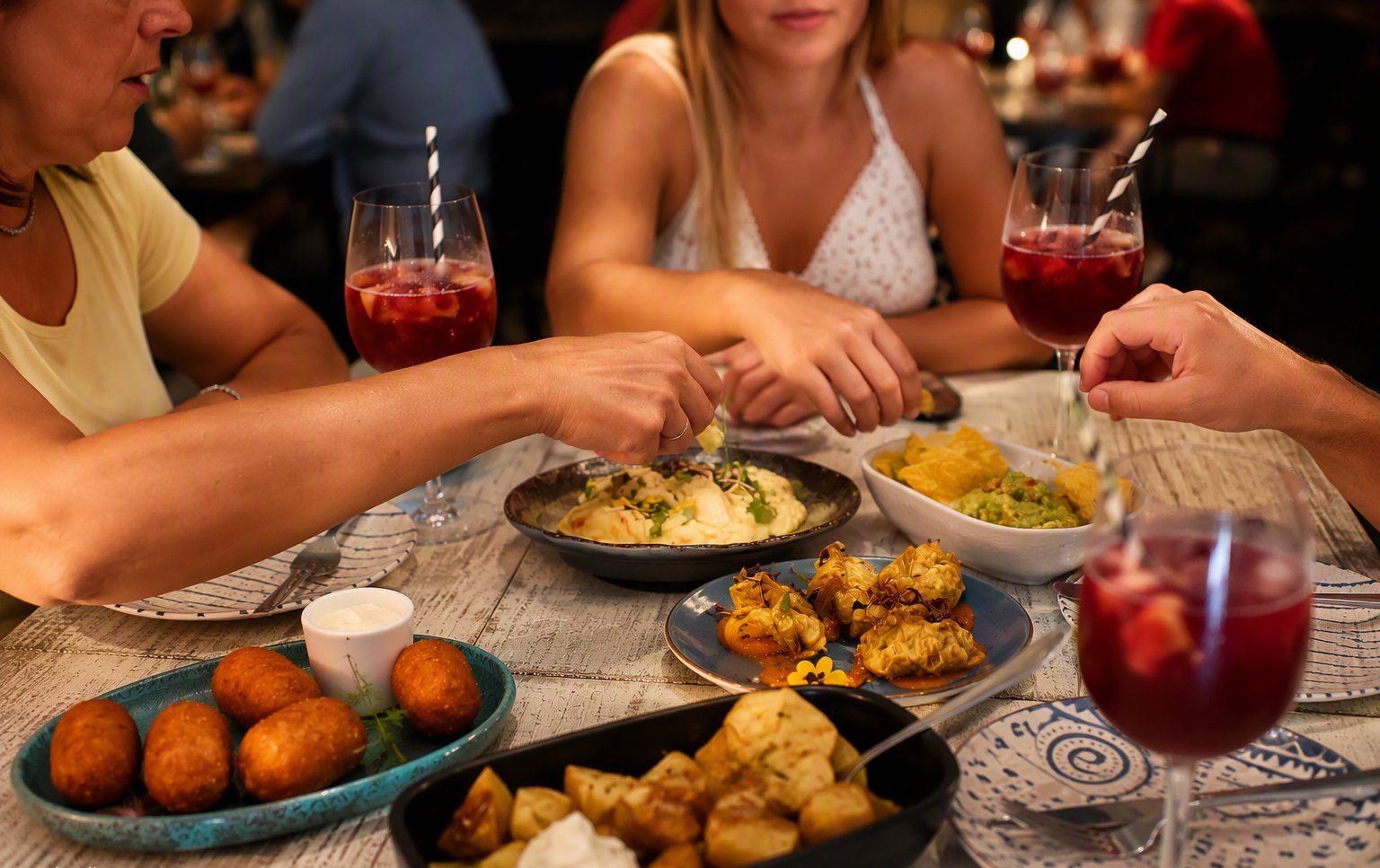 Friends sharing tapas and sangria at Pampa